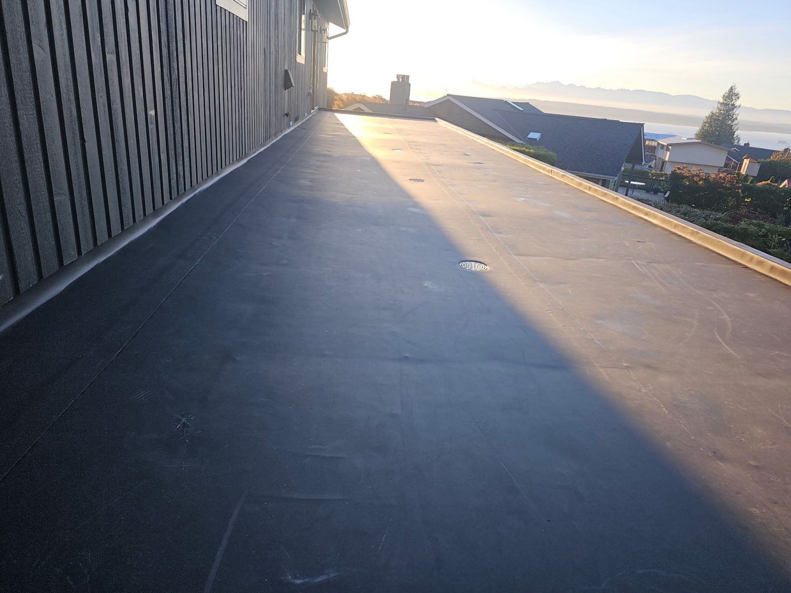 Tapered ISO insulation system creating positive drainage on a low-slope roof project on the Shoreline/Edmonds line by Denali Roofing