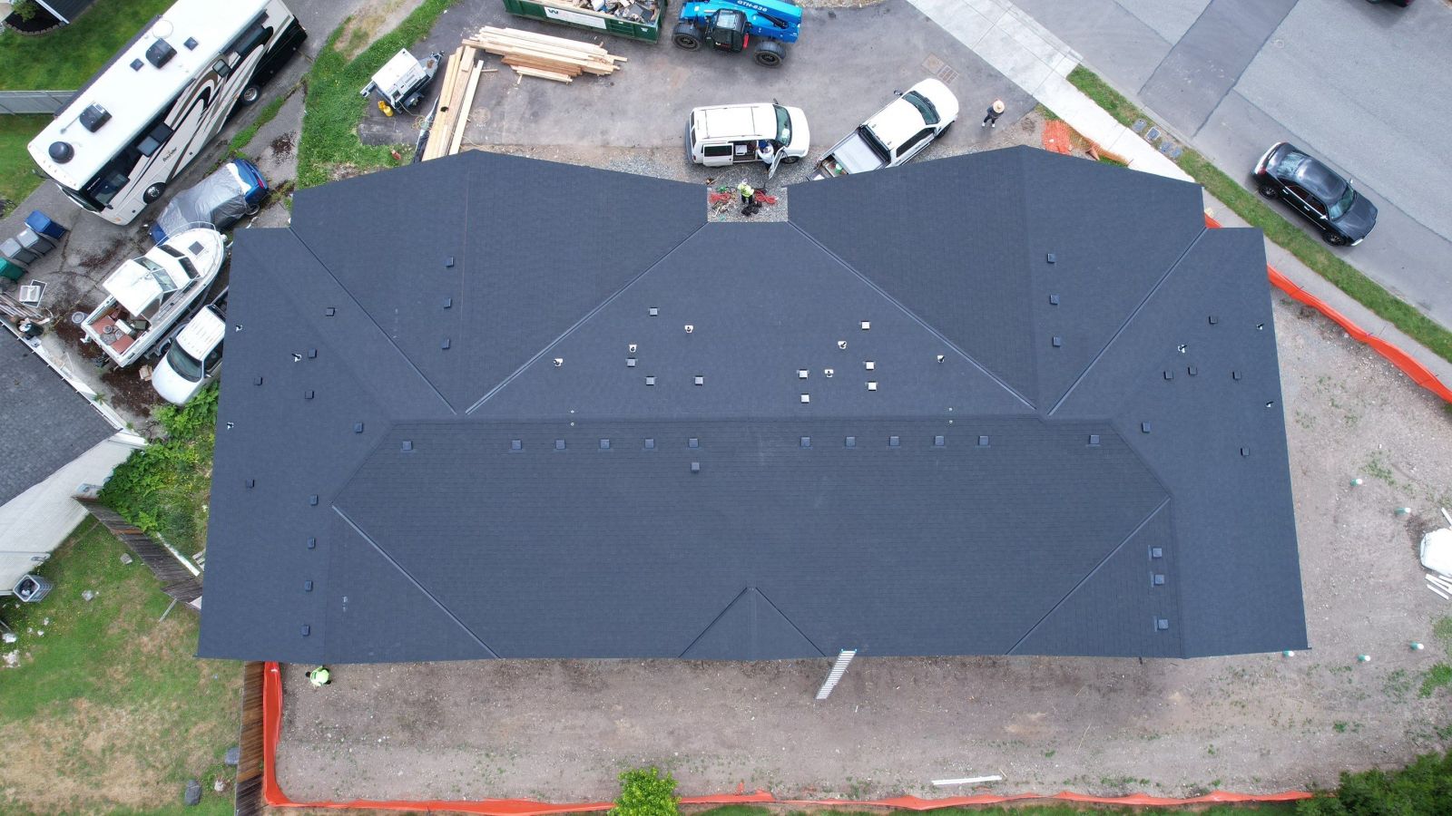 Completed Arlington new-construction roof in cinder black CertainTeed Shadow Ridge